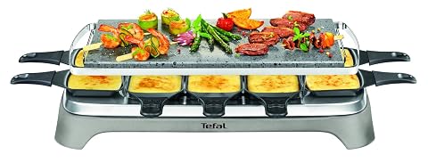 Appareil à raclette en inox avec pierre de lave, coupelles et grattoirs sur une table en bois clair