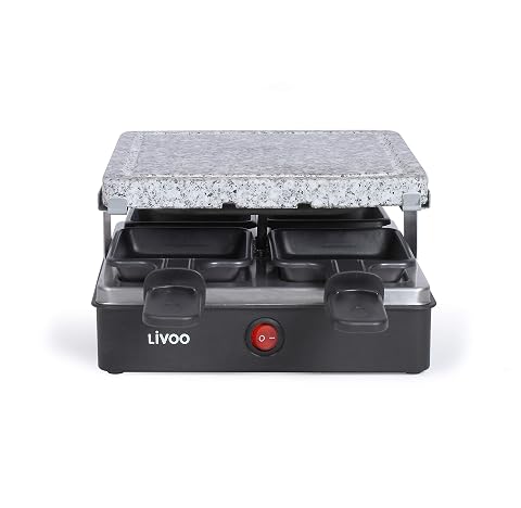 Appareil à raclette noir avec grill en granite et quatre caquelons sur une table en bois clair