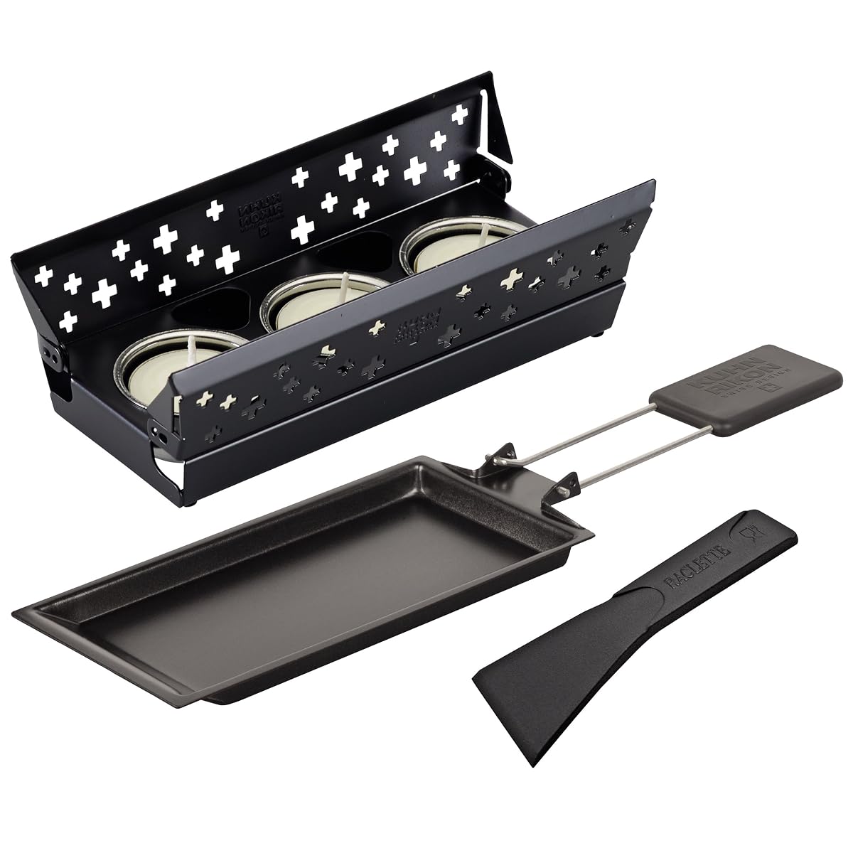 Mini set à raclette noir avec poêlon antiadhésif et trois bougies sur une table en bois clair